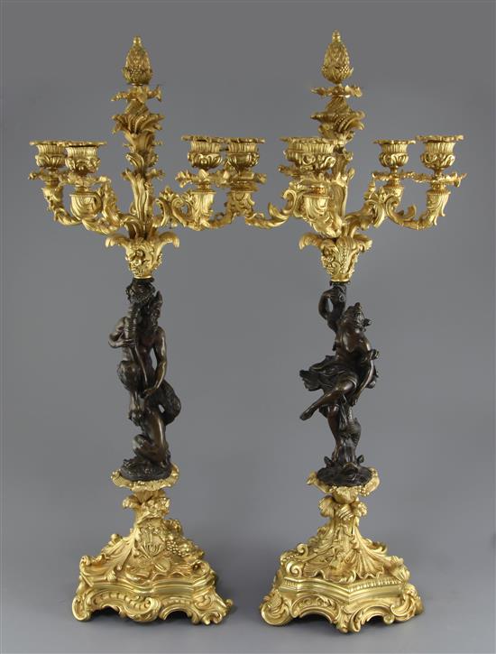 A pair of Louis XVI style bronze and ormolu five light candelabra, H.27in.